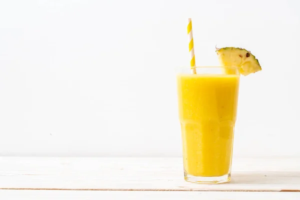 Fresh pineapple smoothie glass on wood table — Stock Photo, Image