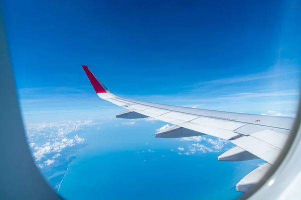 Felhők és ég a repülőgép ablakán keresztül — Stock Fotó