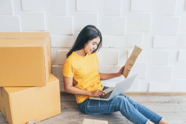 Genç Asya iş başlangıç yukarı online satıcı sahibi kullanarak bilgisayar