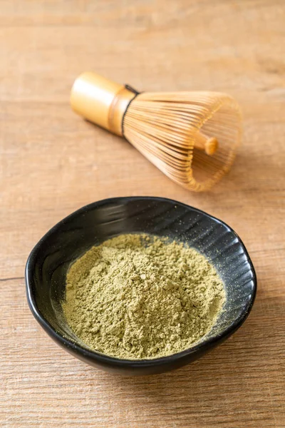 matcha green tea powder with whisk