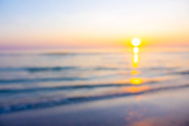 Alacakaranlık gökyüzü ve deniz plajı ile soyut bulanık gün doğumu veya gün batımı