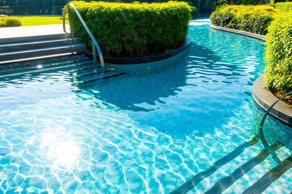 swimming pool in garden decoration in hotel resort