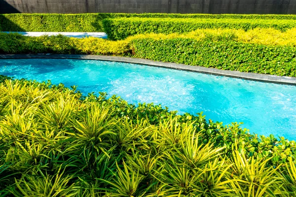 swimming pool in garden decoration in hotel resort