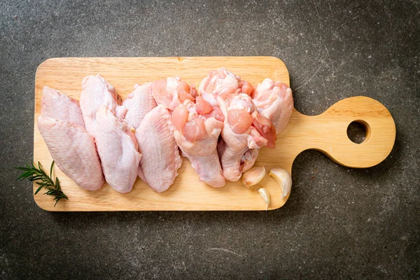 Świeże surowe skrzydełka kurczaka na drewnianej desce — Zdjęcie stockowe