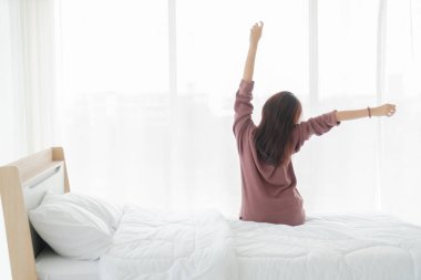 Asian women on bed and waking up in the morning