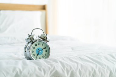 clock on white bed