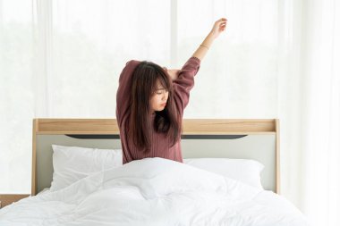 Asian women on bed and waking up in the morning