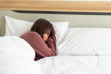 Asian woman sleeping on bed in morning