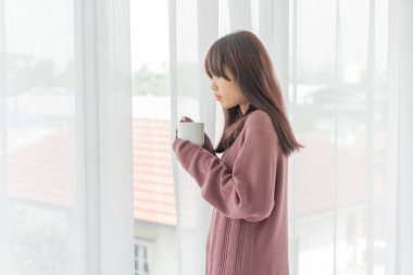 Asian women drinking coffee in the morning