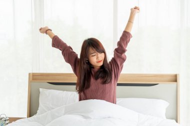 Asian women on bed and waking up in the morning