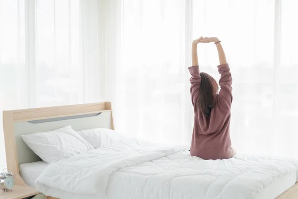 Asian women on bed and waking up in the morning — Stok fotoğraf