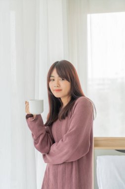 Asian women drinking coffee in the morning