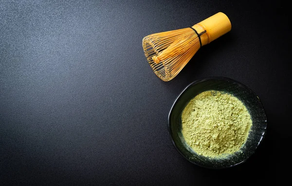 matcha green tea powder with bamboo whisk