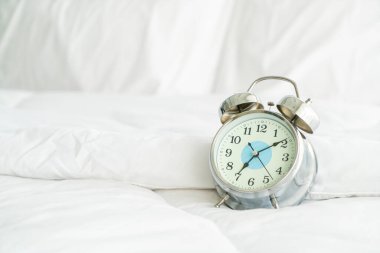 clock on white bed decoration in bedroom