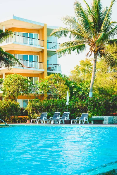 chair pool around swimming pool in hotel resort - holidays and vacations concept