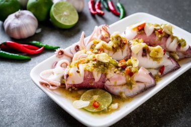 Baharatlı biber ve limon soslu haşlanmış mürekkep balığı veya ahtapot.