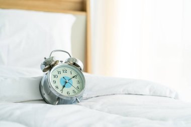 clock on white bed decoration in bedroom