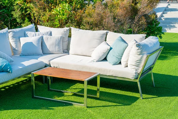 comfortable pillows on outdoor patio chair and table in garden