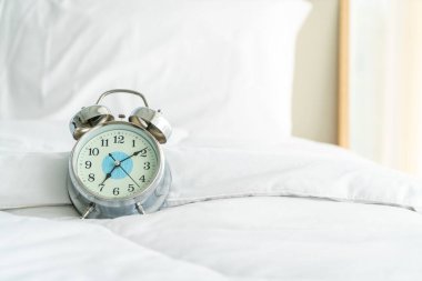clock on white bed decoration in bedroom
