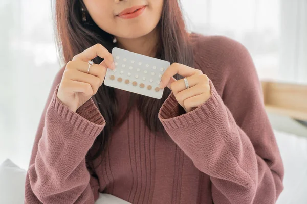 beautiful Asian women holding Birth control pill