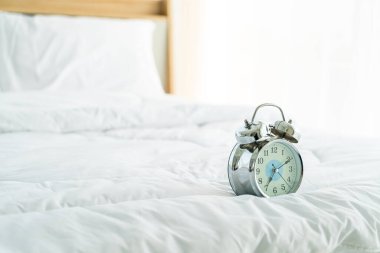 clock on white bed decoration in bedroom