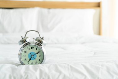 clock on white bed decoration in bedroom