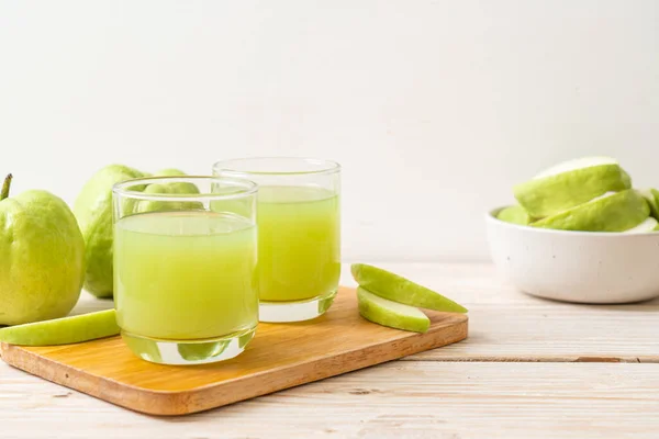 fresh guava juice glass with fresh guava fruit on wood table