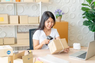 İş yerinde paketleme kutusuyla çalışan Asyalı Kadın işyeri sahibi - çevrimiçi alışveriş KOBİ girişimcisi veya serbest çalışma konsepti