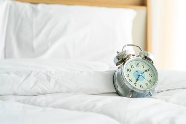 clock on white bed decoration in bedroom