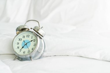 clock on white bed decoration in bedroom