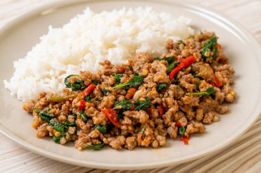 Stir fried Thai basil with minced pork and chilli on topped rice - Thai local food style clipart