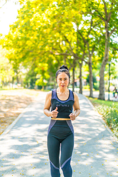 Asian woman jogging and running at park