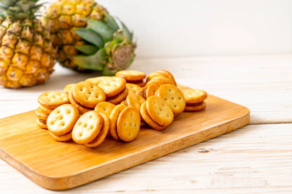biscuits with pineapple jam on wood background