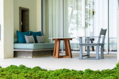 empty outdoor patio chair and desk on balcony