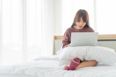 Evde dizüstü bilgisayarla çalışan Asyalı kadınlar.