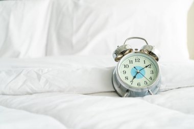 clock on white bed decoration in bedroom