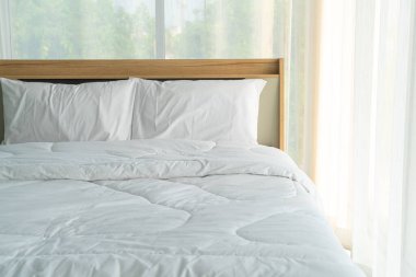 white comfortable pillow on bed decoration in bedroom