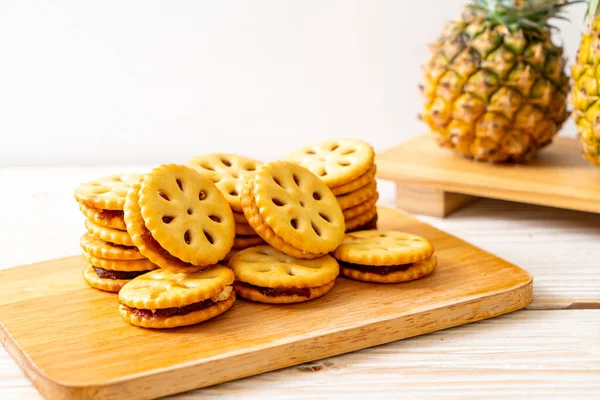 biscuits with pineapple jam on wood background