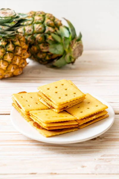 cheese biscuits with pineapple jam on wood background