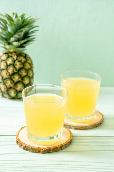 fresh pineapple juice on wood background