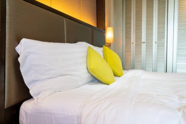 Otel odasındaki yatakta rahat yastık süslemesi