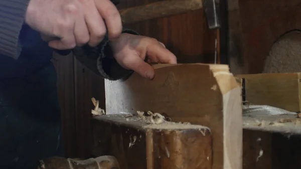 Close up, carpinteiro bate um prego em uma tábua de madeira com um martelo — Fotografia de Stock