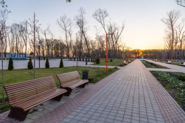 Boş park, akşamları banklar ve ara sokaklar gün batımında