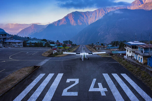 Lukla, NEPAL - December 2, 2019: Lukla airport. In the frame of the airport runway and taking off the plane. Nepal. Everest trekking.