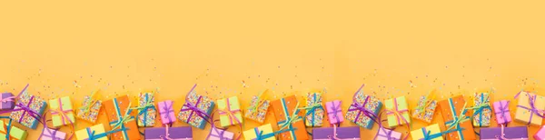 Colored gift boxes with colorful ribbons. White background. Long — Stock Photo, Image