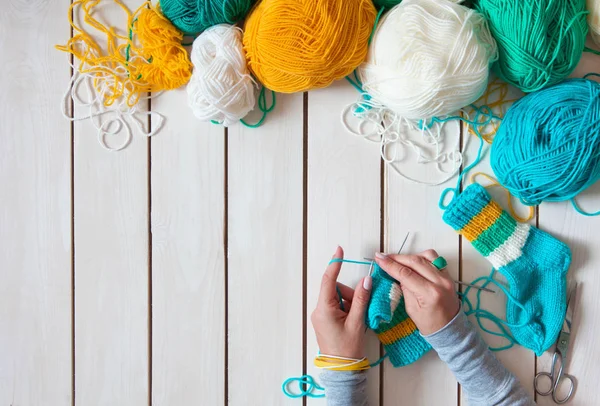 Bir kadın çocuk örgü iğneleri ile örgü çorap dokuma kumaşlar. Şerit