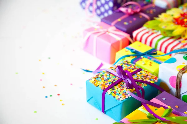 Colored gift boxes with colorful ribbons. White background. Gift