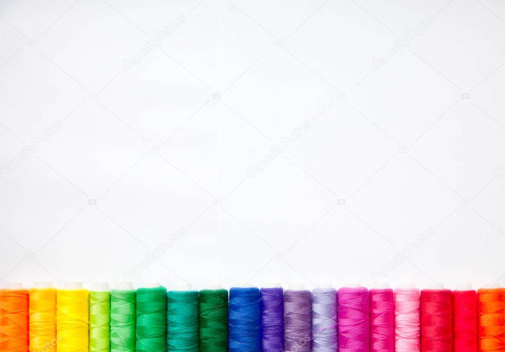 Color thread for sewing. White background.