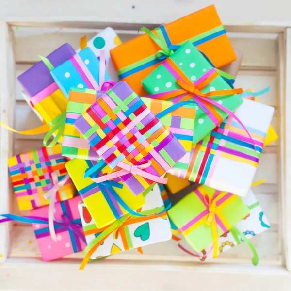 Colored gift boxes with colorful ribbons. Heart color. White bac — Stock Photo, Image