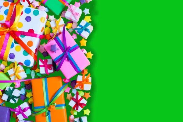 Colored gift boxes with colorful ribbons. Green background. Gift